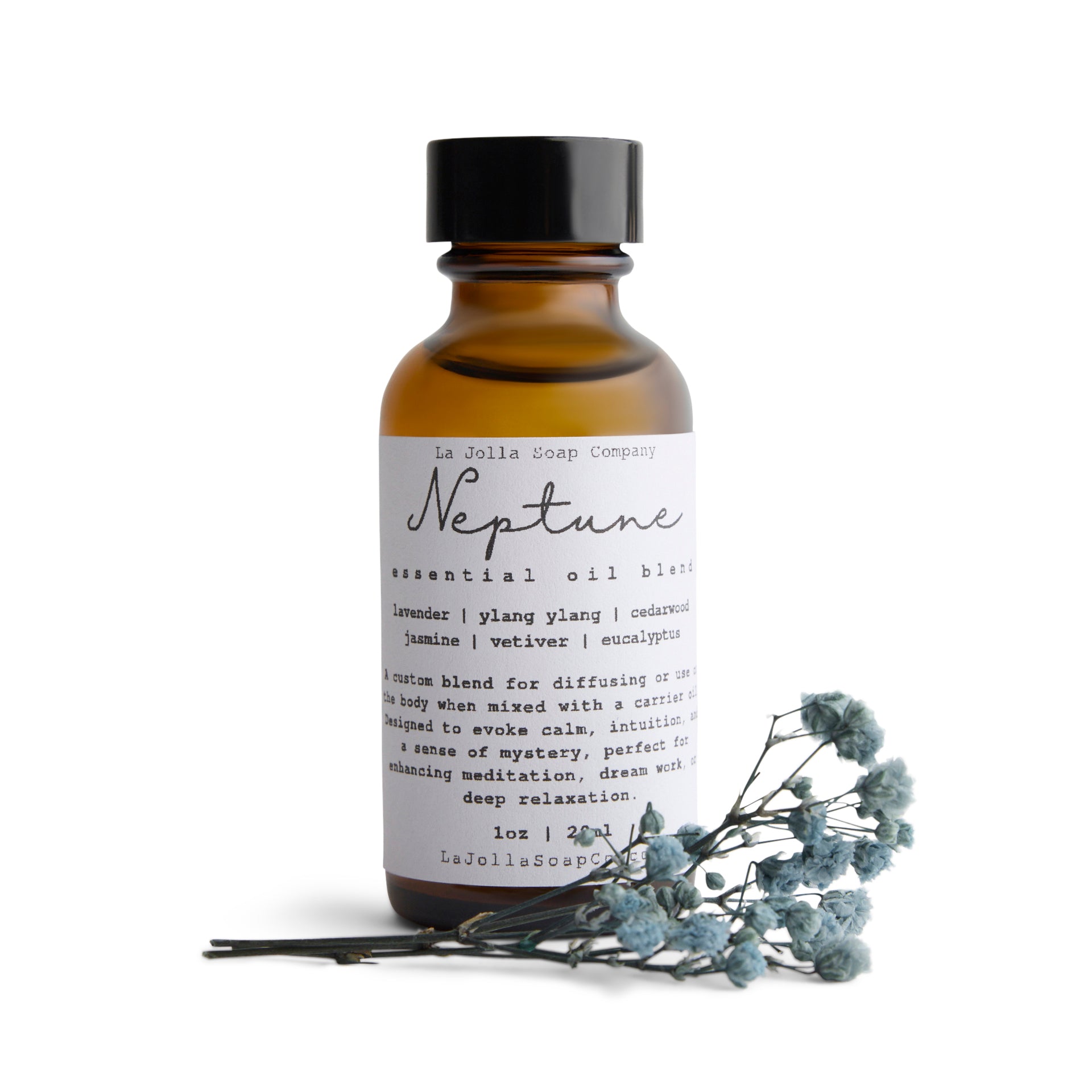 A bottle of Neptune Essential Oil Blend with a small bouquet of dried blue flowers laid in front, set against a clean natural white backdrop, evoking the calming and refreshing essence of the ocean.