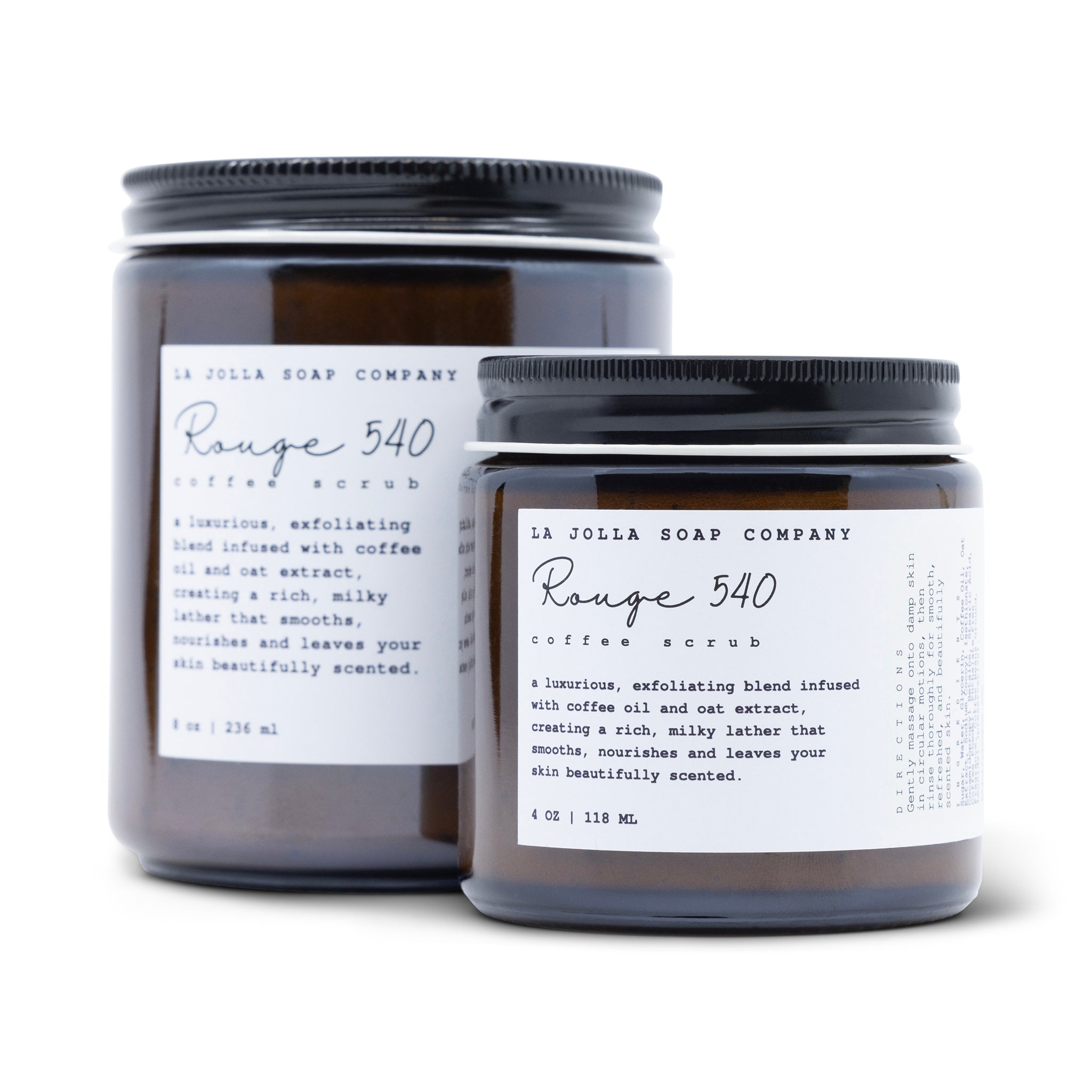 Dark amber jars of La Jolla Soap Company Rouge 540 Coffee Scrub with a minimalist white label, featuring the product name in elegant script and a brief description of the luxurious, exfoliating blend infused with coffee oil and oat extract.