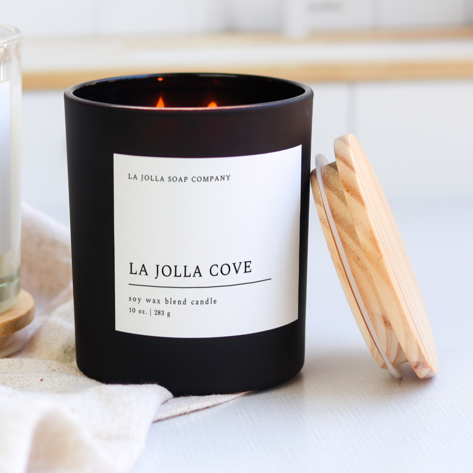 La Jolla Cove Candle in a glass jar, inspired by the scenic La Jolla Cove, with fresh scent notes evoking ocean breezes, sunlit coastal cliffs and the tranquility of seaside air.