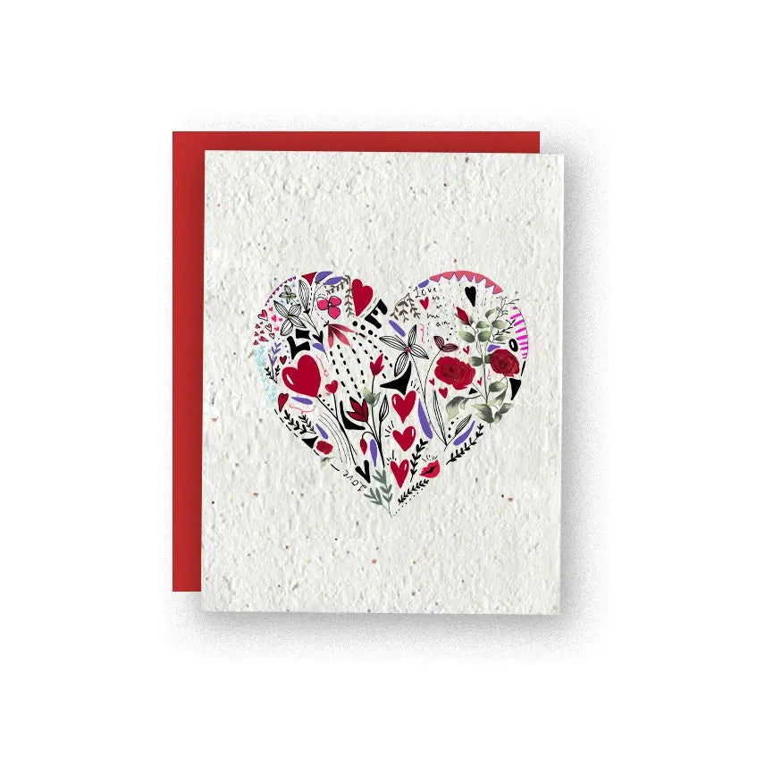 An artisan greeting card, with the face showing a big heart and within the heart is beautiful painted flowers and smaller hearts.  The paper is biodegradable embedded with wildflower seeds.