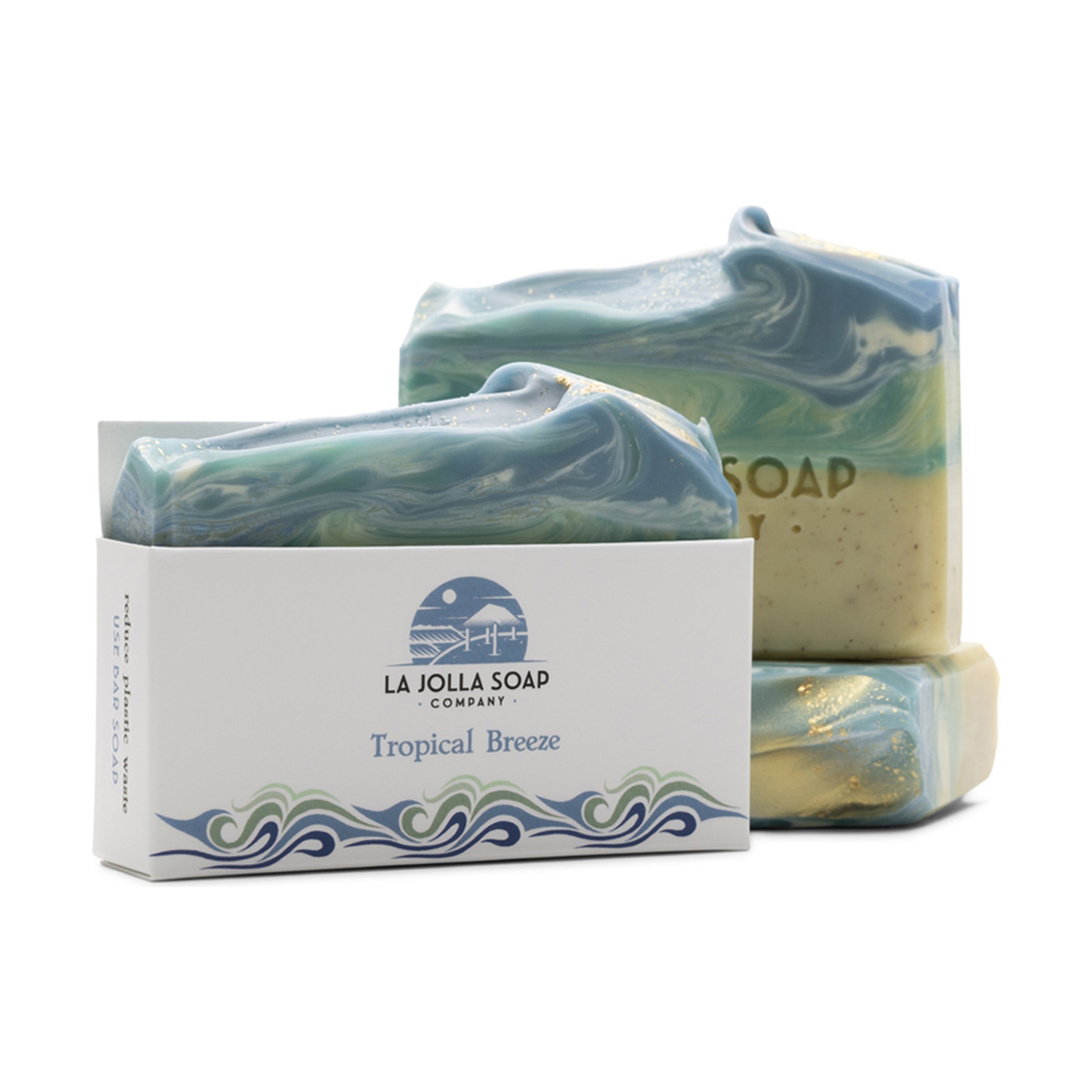 Three bars of marbled soap with a box labeled 'La Jolla Soap Company Tropical Breeze' on a white background.