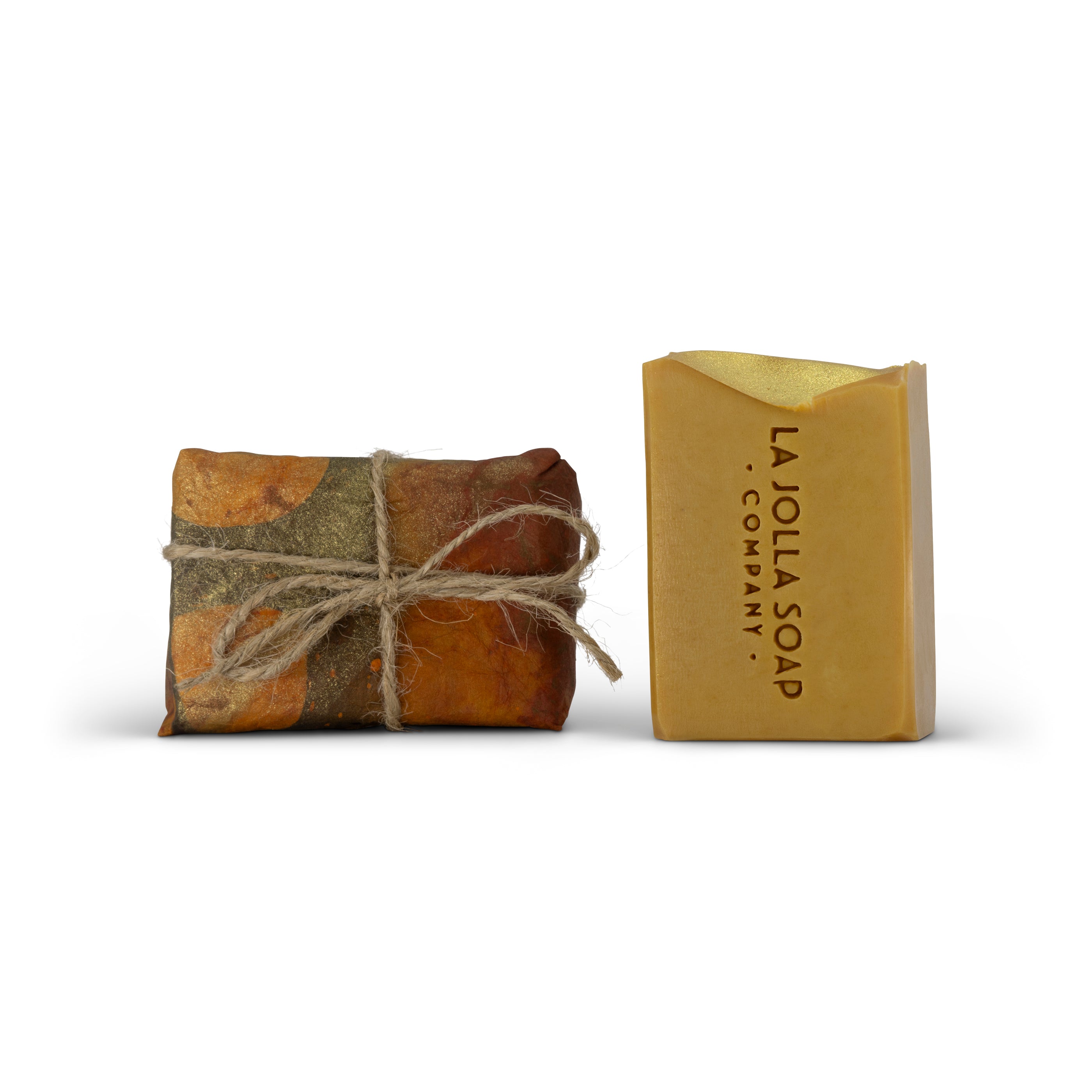 Two bars of soap, one wrapped in twine and the other unwrapped, on a white background with 'La Jolla Soap Company' branding.