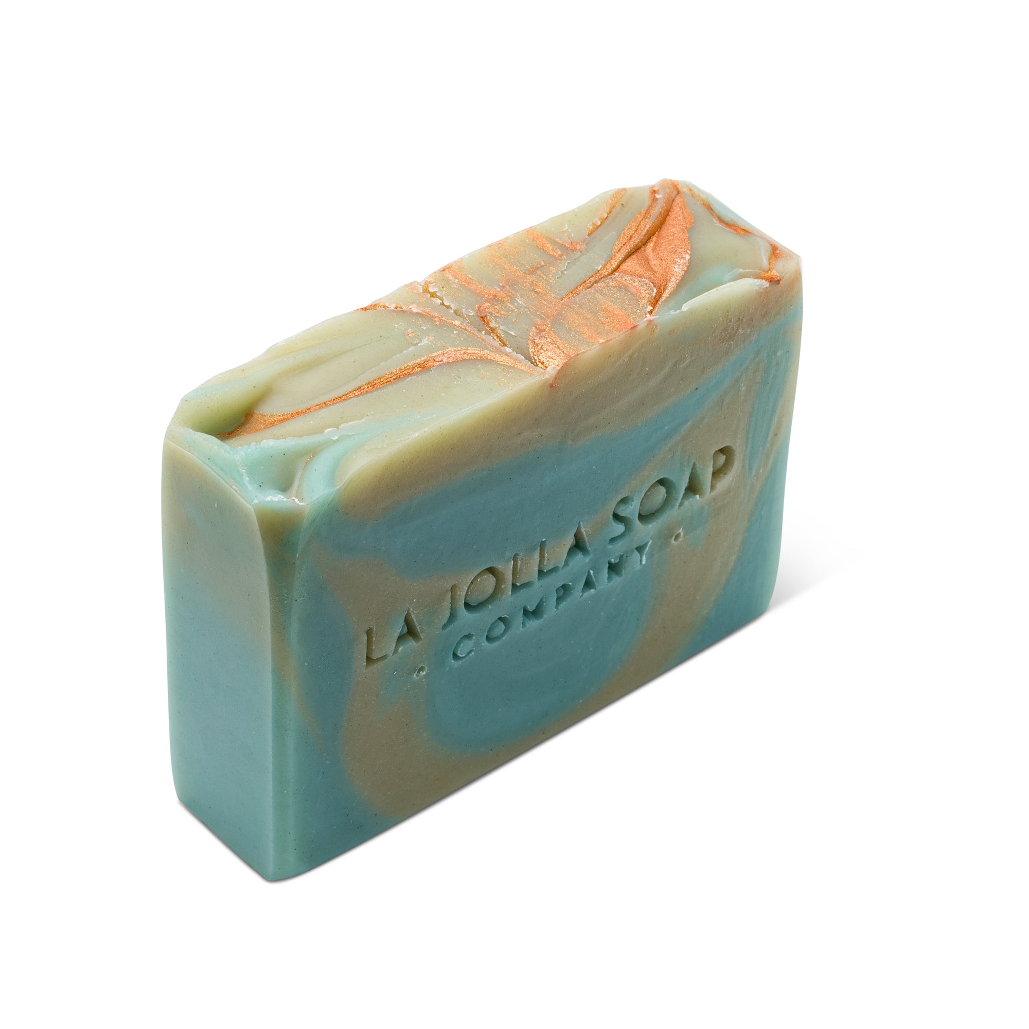 Top view of a Soap Bar that is indigo blue with sea green colored swirls, Top side has golden copper swirls. La Jolla Soap Company's Sea Clay Soap