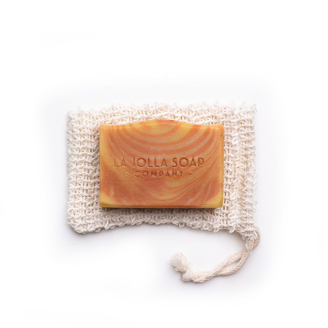 Natural soap bar with yellow and orange stipes. Natural fiber soap pouch wash cloth.
