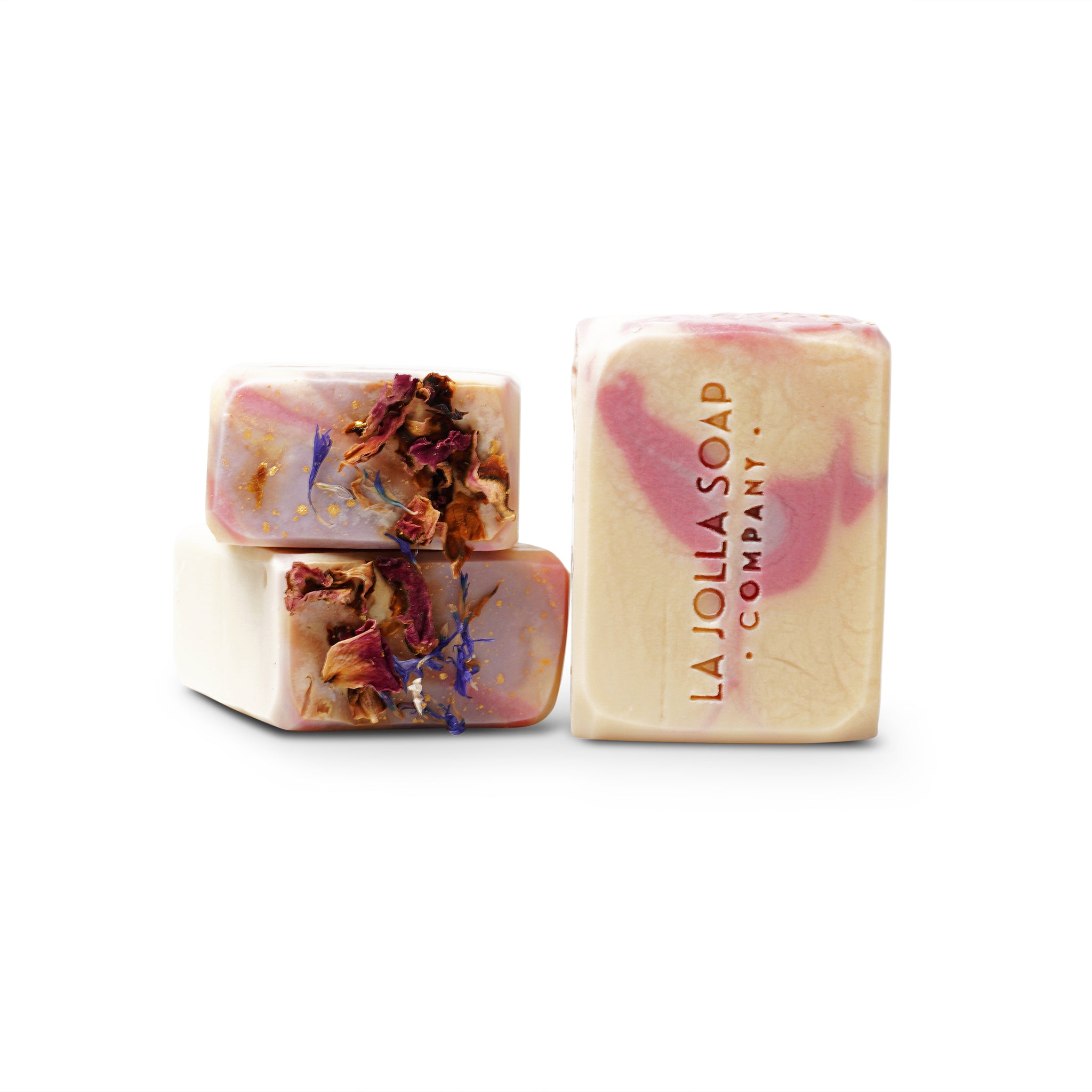 A handcrafted Milky Rose and Lavender Goat Milk Soap with a creamy, soft white base and delicate pink swirls. The top is adorned with a shimmering gold finish and dried rose petals creating an elegant, floral-inspired design.